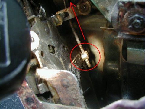 1993 Ford Bronco - Close-up view of a throttle linkage adjustment mechanism, with a red circle highlighting the adjustment nut.