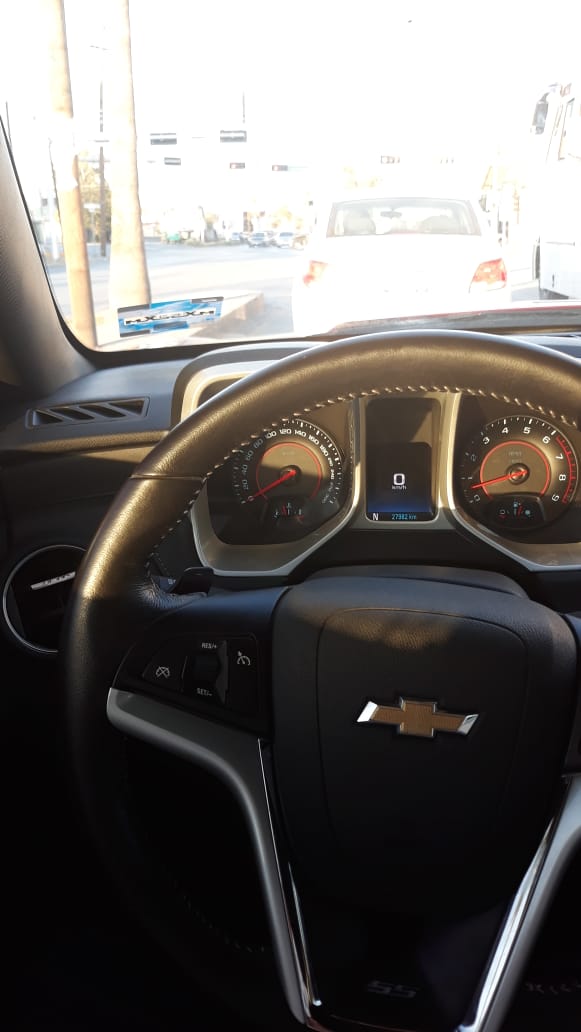 Chevrolet interior showing steering wheel, bowtie logo and instrument cluster reading 0 km/h
