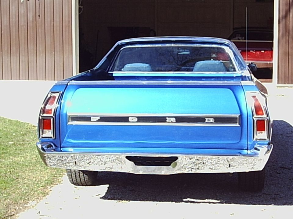 Blue Ford pickup truck rear view, chrome bumper, tailgate with FORD lettering