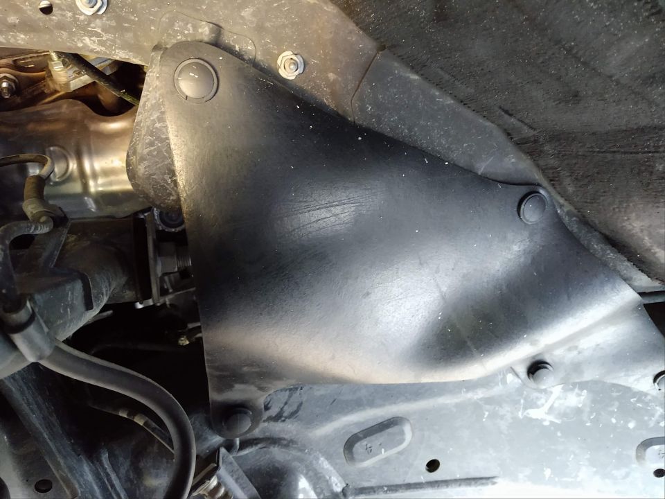 Underbody view of a black plastic shield on a Toyota 4Runner.