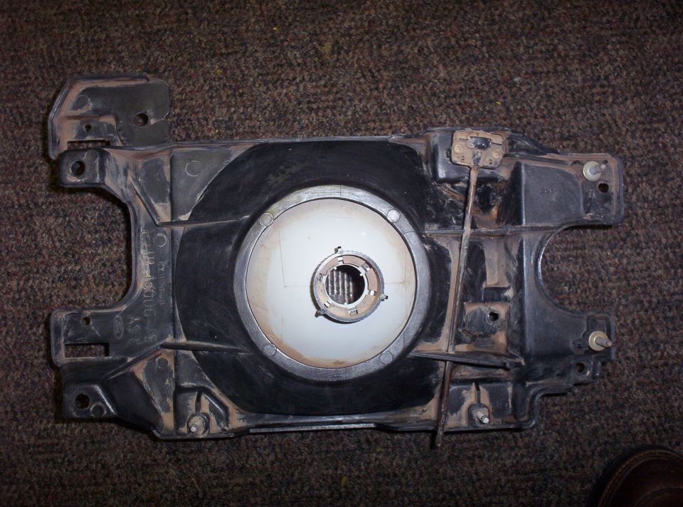Headlight assembly with visible text and mounting points