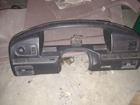 1994 Ford Bronco - A black plastic dashboard trim piece is shown lying on a concrete floor. Visible labels include "REAR WINDOW", "REAR DEF", "4x4", and "LOW…