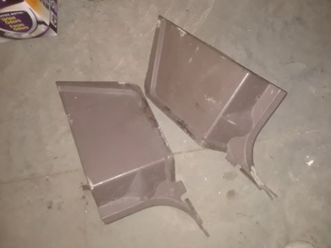 1994 Ford Bronco - Two car door panels are shown on a concrete floor, possibly for a Ford Bronco.