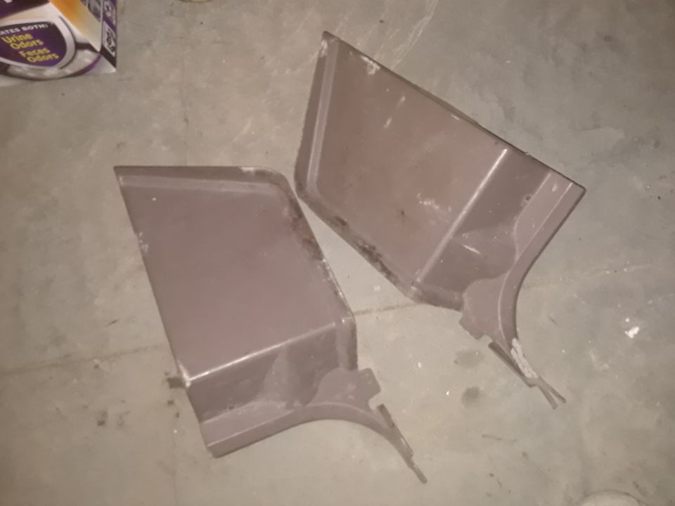 two brown car door panels on a concrete floor