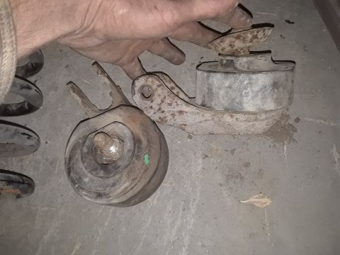 1994 Ford Bronco - Close-up of old, rusty vehicle suspension components, likely for replacement or repair.