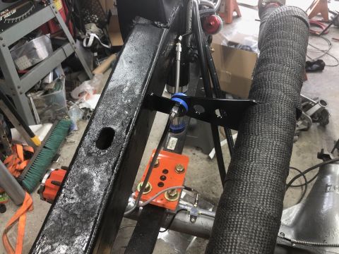 1992 Jeep Wrangler - Custom exhaust modification on a Jeep, showing heat wrap and suspension linkage.