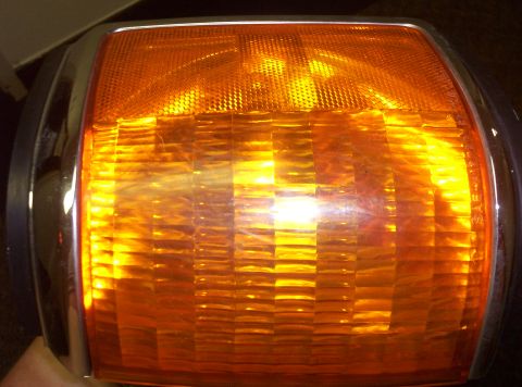 1988 Ford Bronco - Close-up of an amber turn signal assembly, likely from a vehicle's front end.