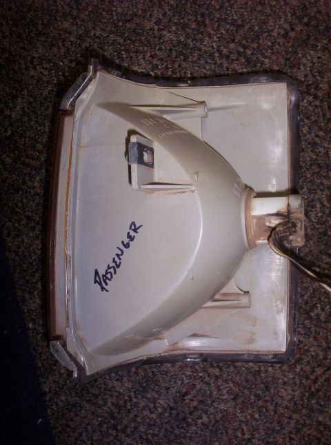 1988 Ford Bronco - The interior of a passenger side turn signal housing is shown, with 'PASSENGER' handwritten on the casing.