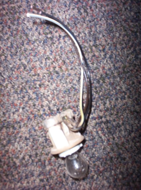 1988 Ford Bronco - A close-up of a vehicle's turn signal bulb socket with attached wiring.