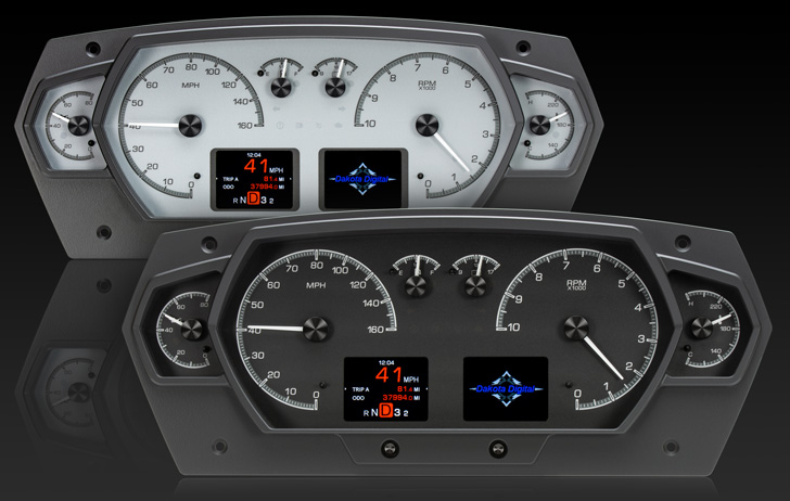 Two Dakota Digital instrument clusters, one white-faced and one black-faced.