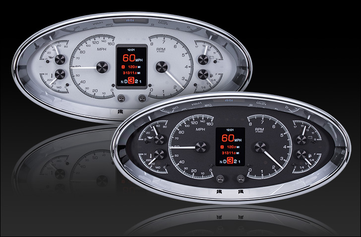 Two oval digital gauge clusters with chrome bezels, one white-faced and one black-faced.