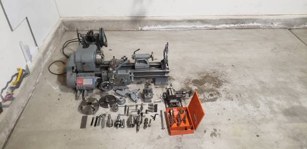 Metal lathe with various chucks, bits, and a drill bit set