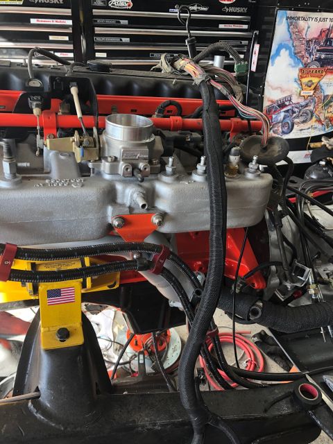 1992 Jeep Wrangler - Engine assembly with intricate wiring and throttle body, mounted on a yellow support stand.