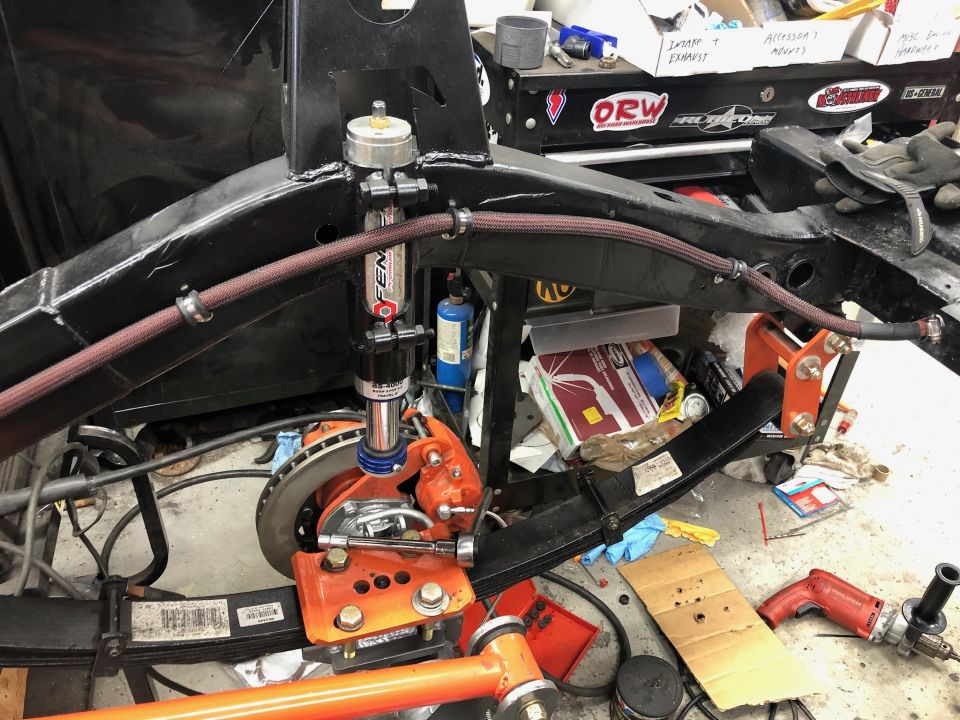 Close-up of a Jeep Wrangler suspension component with a shock absorber and leaf spring