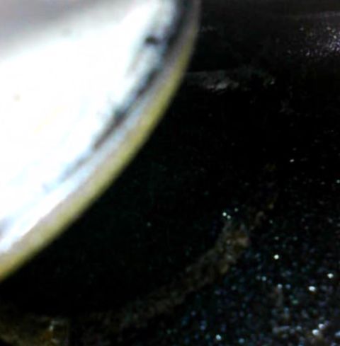 1996 Ford Bronco - A close-up view of a vehicle's tire and wheel well, with the ground visible beneath.