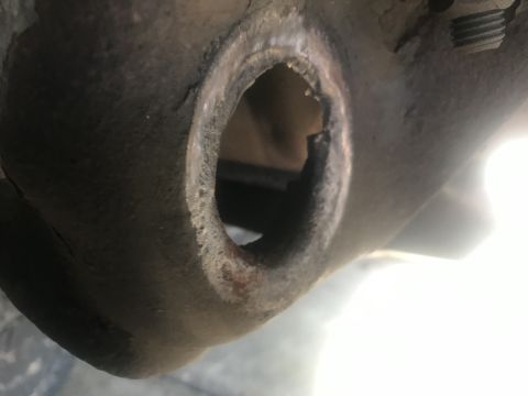 1994 Ford Bronco - A close-up view of a damaged metal component, possibly from a vehicle's suspension system, with a watermark at the bottom right.