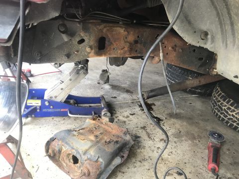 1994 Ford Bronco - Vehicle frame undergoing repair, showing significant rust and removed components.