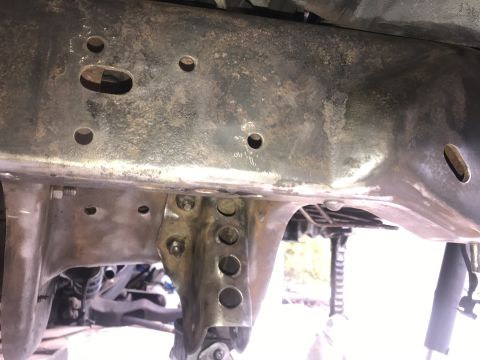 1994 Ford Bronco - Close-up of a vehicle's undercarriage, showing the frame structure.