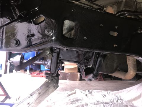 1994 Ford Bronco - Close-up view of the undercarriage, showing frame and suspension components during a rebuild.