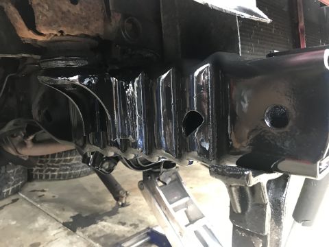 1994 Ford Bronco - Vehicle frame and suspension parts are visible, supported by jack stands during work.