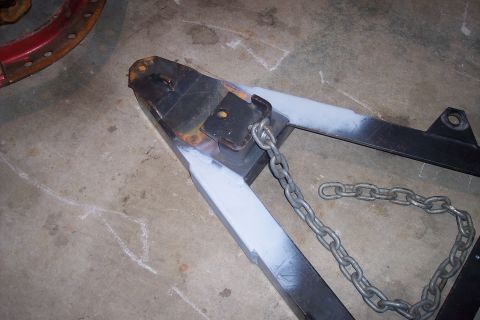 1973 Ford F-250 - A trailer hitch assembly with chains is shown, with areas of fresh paint and visible rust.