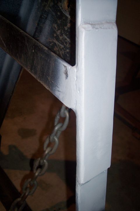 1973 Ford F-250 - A close-up view of a vehicle's frame, showing a metal chain connected to a structural component.