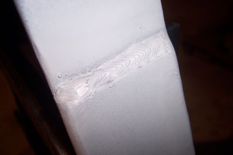 1973 Ford F-250 - A close-up view of a welded seam on a vehicle panel, indicating repair work.