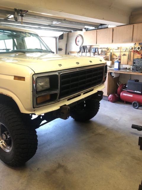 1981 Ford Bronco - A Ford Bronco is parked in a garage with tools and equipment visible in the background.