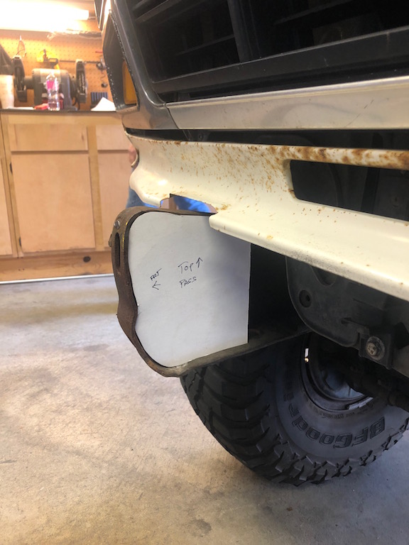 Front bumper with paper template showing 'Top' and 'Faces'