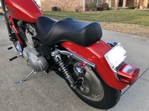 2002 Harley-Davidson Sportster Custom - Rear view of a red 2002 Harley-Davidson Sportster Custom motorcycle.
