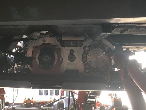 1992 Jeep Wrangler - Close-up of vehicle transfer case and drivetrain parts, possibly during maintenance.
