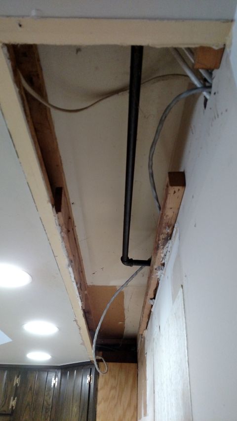 1980 Yugo Vega - Exposed ceiling joists reveal plumbing and wiring during a kitchen remodel project.