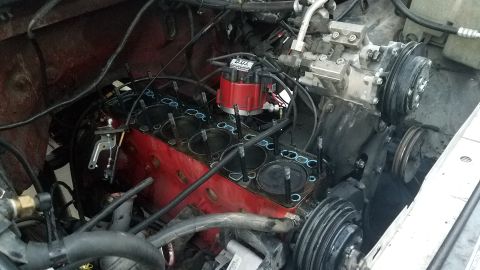 1985 Ford Bronco - Engine block disassembled, with cylinder heads off and pistons exposed.