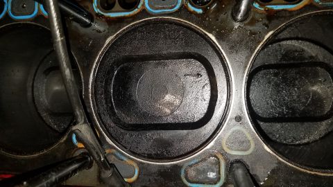1985 Ford Bronco - Engine cylinders and pistons show significant carbon buildup and wear.