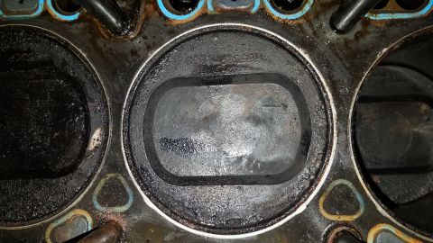 1985 Ford Bronco - This image shows the inside of an engine cylinder, likely requiring repair due to wear and deposits.