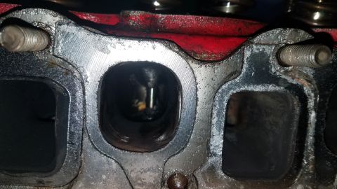 1985 Ford Bronco - Engine cylinder head ports showing wear and carbon deposits.