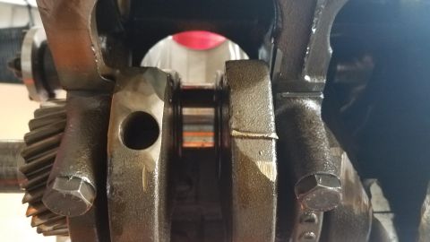 1985 Ford Bronco - Close-up view of engine crankshaft and connecting rods, showing internal engine components.