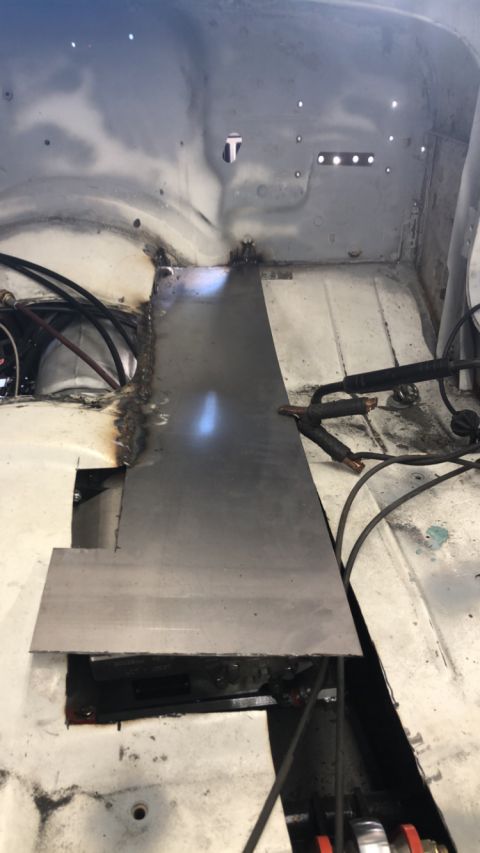1992 Jeep Wrangler - Metal patch being welded into the floor of a vehicle during repair work.