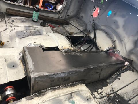 1992 Jeep Wrangler - Metal fabrication work is underway on the interior floor of a vehicle, with new panels being welded into place.