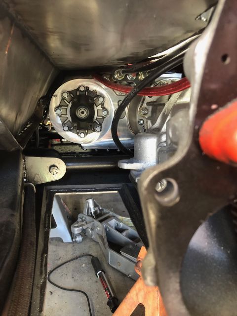 1992 Jeep Wrangler - Close-up view of a vehicle's underbody, focusing on the transmission area with visible hoses and a circular metal part.