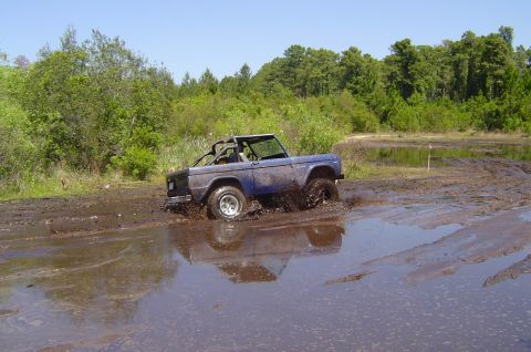 1974 Ford Bronco - This 1974 Ford Bronco is navigating a challenging muddy terrain.