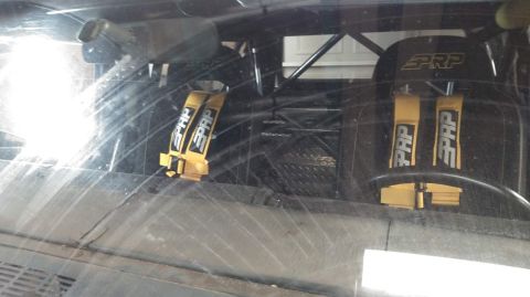 1978 Ford Bronco - Interior view of a vehicle with racing seats and yellow PRP harnesses.