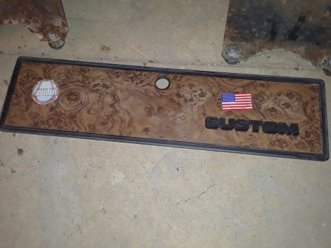 1994 Ford Bronco - This custom trim piece features a wood grain finish, an American flag decal, and a Kansas City Royals logo, suggesting a personalized touch.