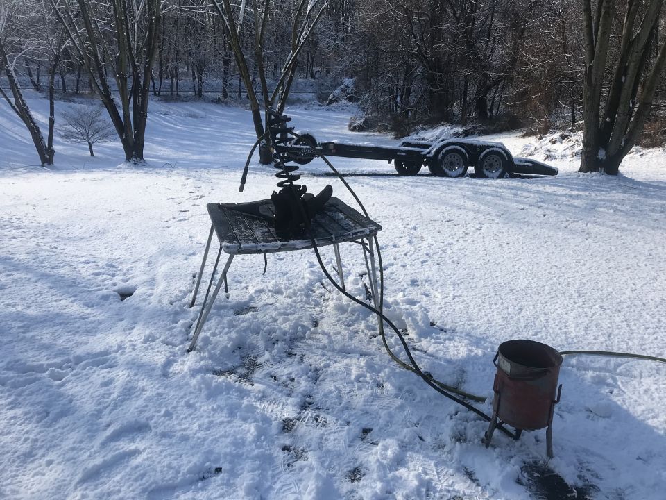 trailer in snow with parts on a table
