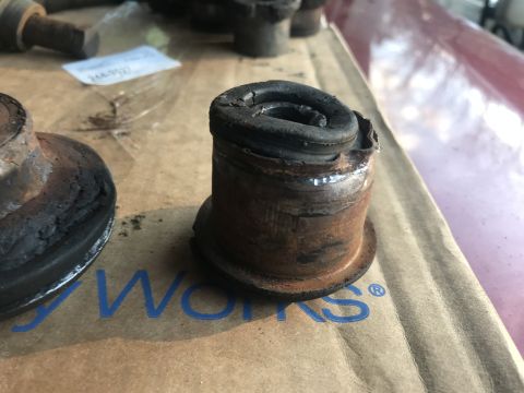 1994 Ford Bronco - A heavily worn rubber bushing is shown, indicating a need for replacement.