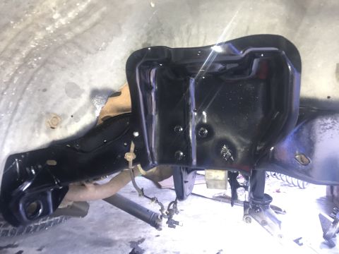 1994 Ford Bronco - Close-up view of vehicle frame and suspension parts during a rebuild.