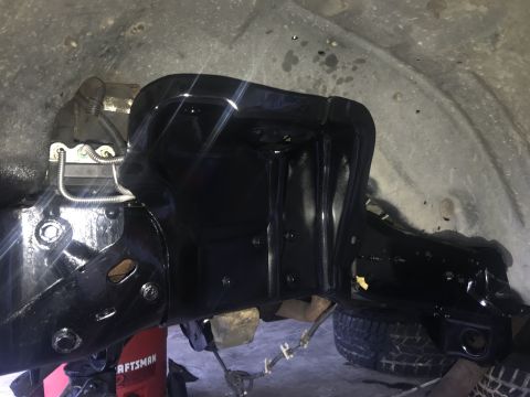 1994 Ford Bronco - Close-up of vehicle frame and suspension components during a rebuild project.