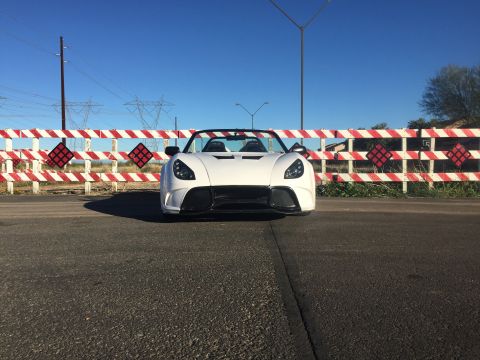 2015 Subaru Impreza - White convertible sports car with black accents parked on asphalt road.