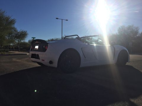 2015 Subaru Impreza - A white convertible sports car is parked outdoors under a bright sun.