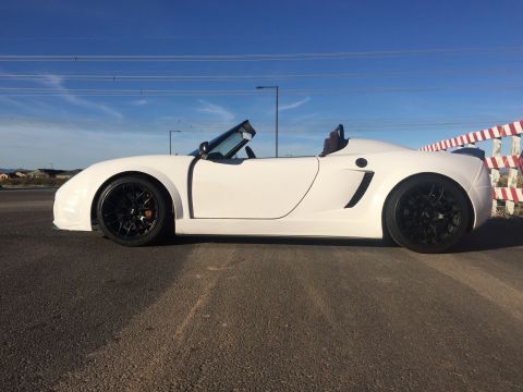 2015 Subaru Impreza - Side view of a white convertible sports car with black wheels.